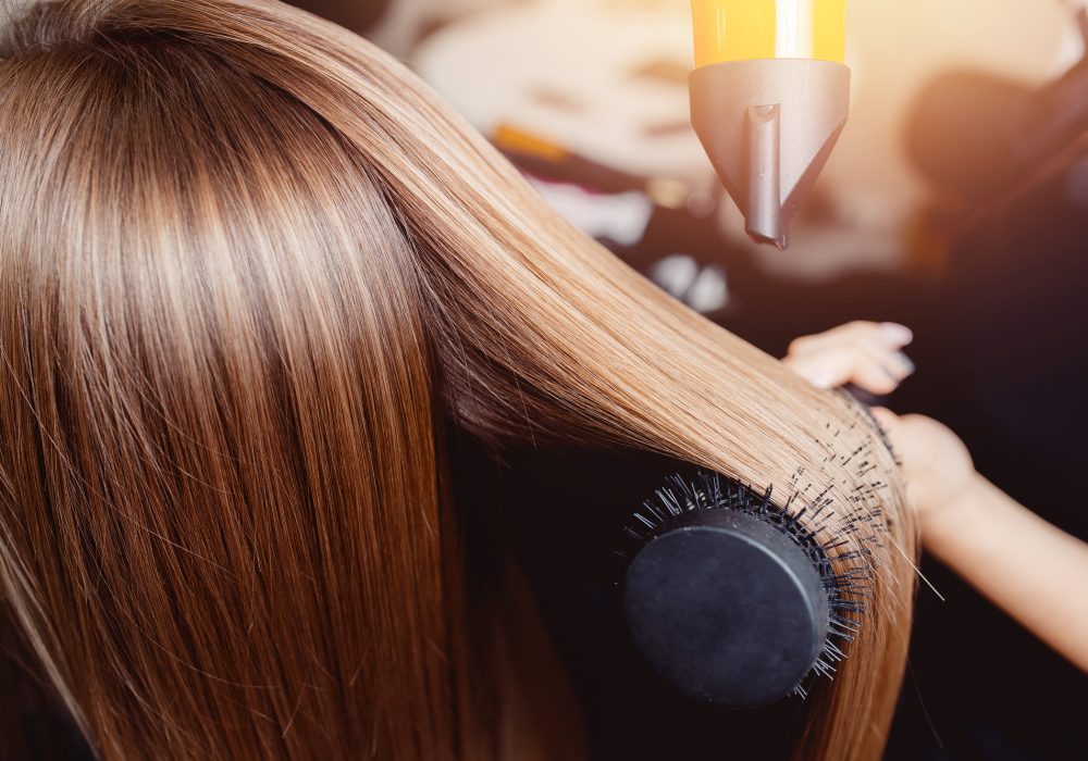 Close-up of hair dryer for hair drying, concept hair salon, female stylist.